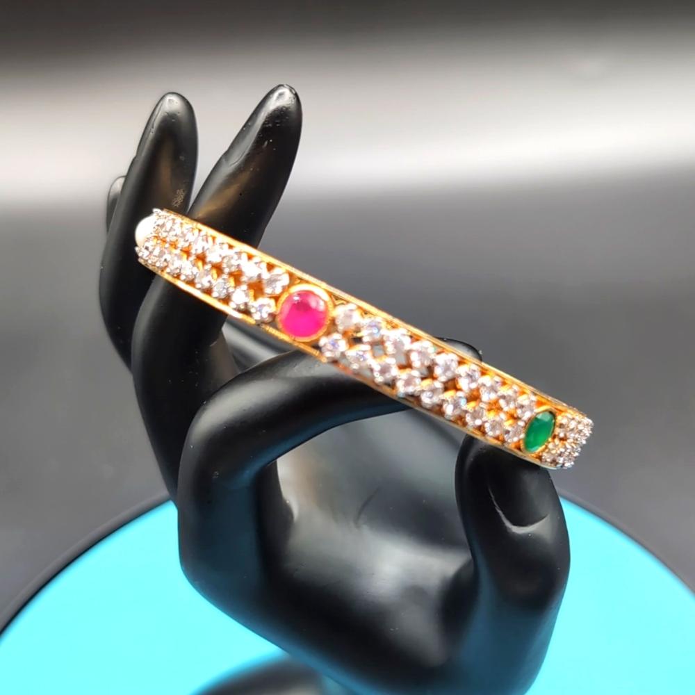 Gold Toned Textured Pattern Bracelet With Rubies And Coloured Faceted Stones